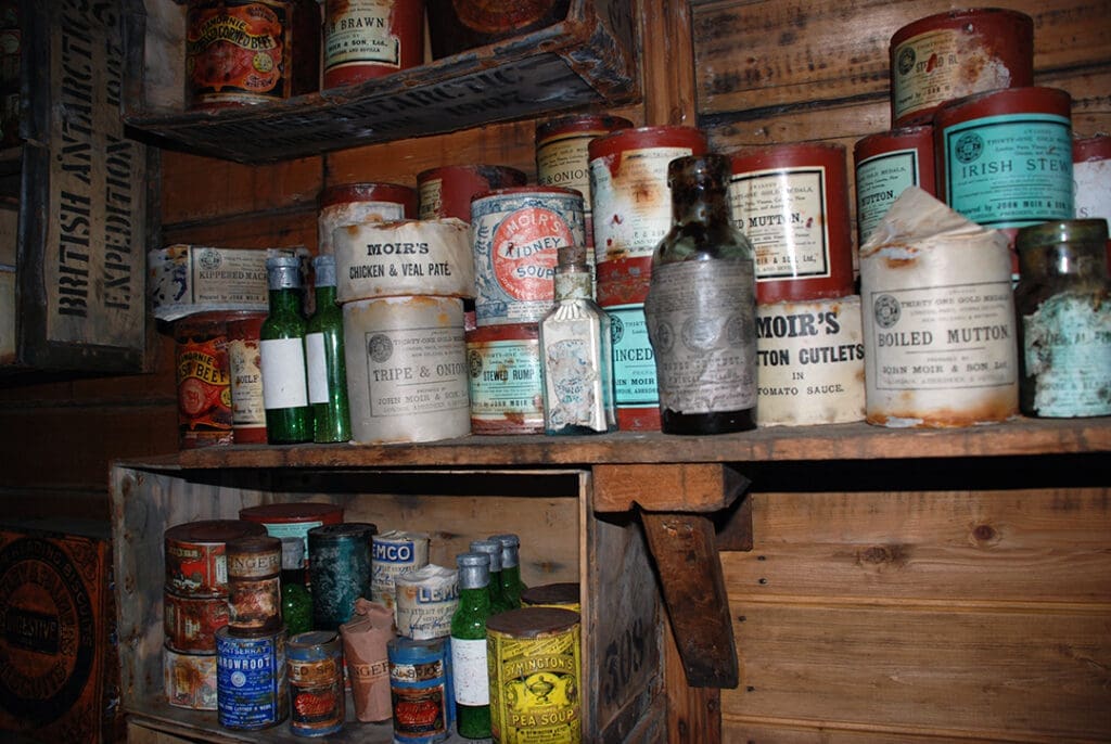 Vintage canned goods on wooden shelves.