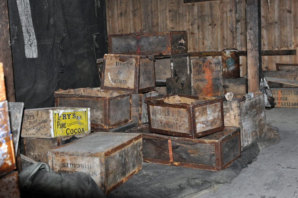 Old wooden crates stacked in rustic storage area.