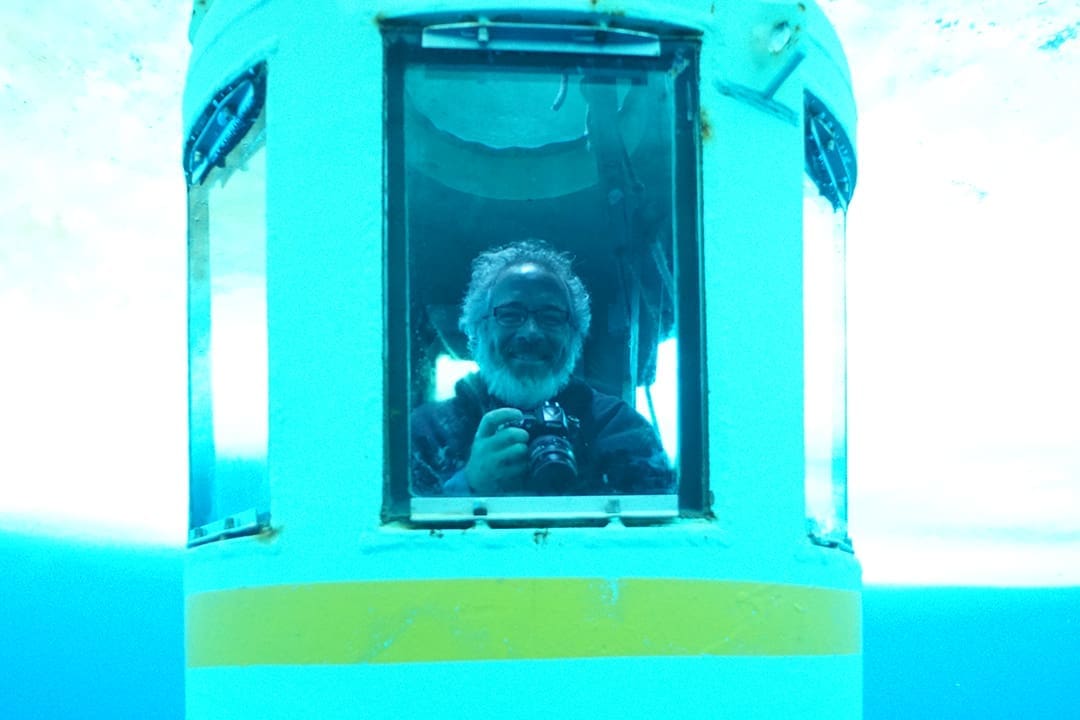 Glenn in an underwater tank looking out