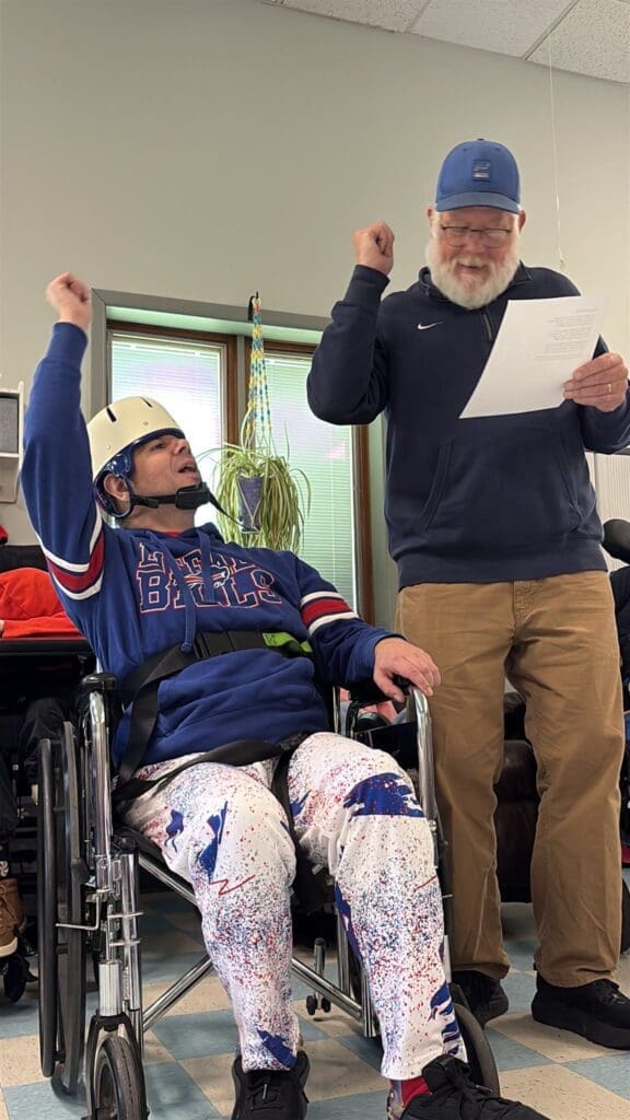 Man in wheelchair and man cheering for Bills